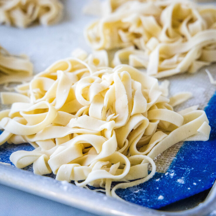 square close up fresh cut pasta on a baking sheet