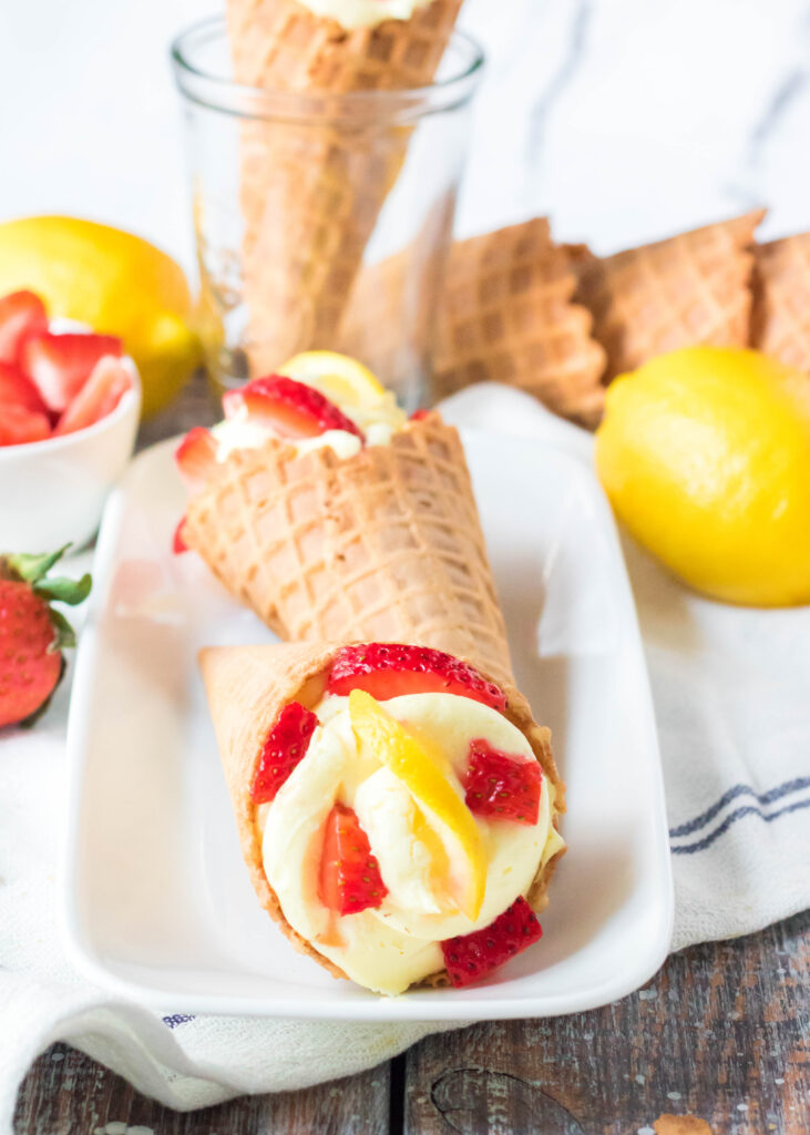 no bake lemon cheesecake in waffle cones with strawberries