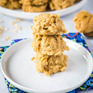 square image of peanut butter cookies close up stacked on white plate