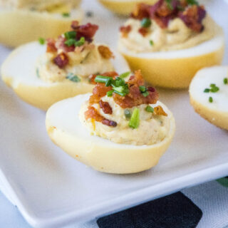close up smoked deviled eggs on a white platter