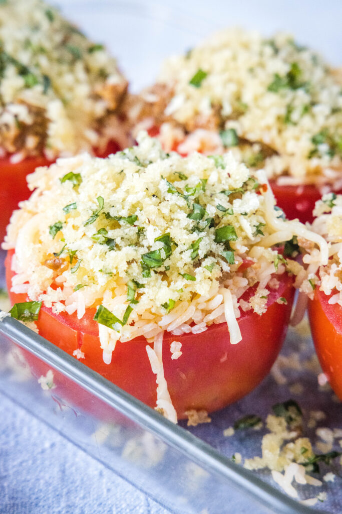 stuffed tomatoes ready for the oven in baking dish