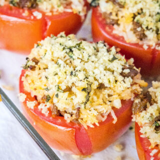 close up baked stuffed tomatoes in baking dish