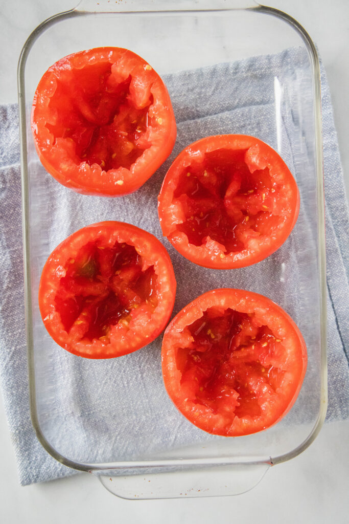 hollowed out tomatoes in baking dish