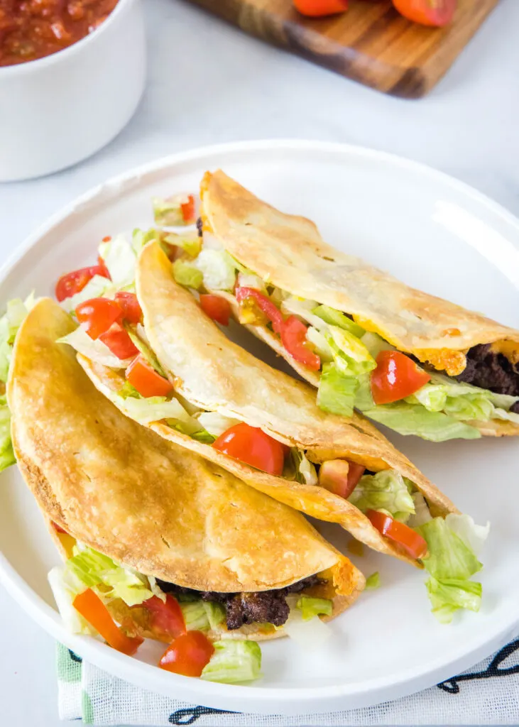 air fryer crispy tacos on a white plate