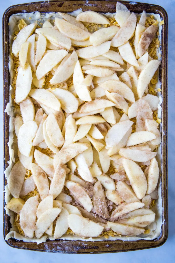 apples arranged in pie crust for apple bars