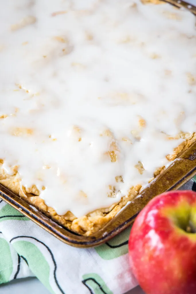 apple bars topped with vanilla glaze in pan