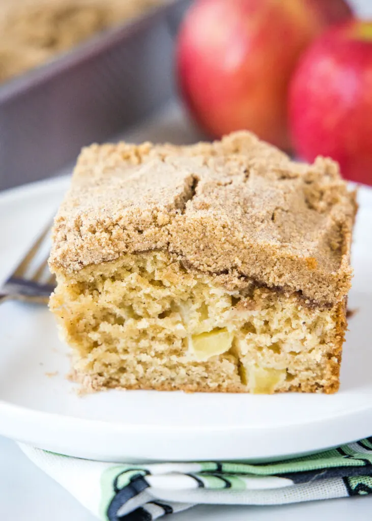 a slice of apple coffee cake on a white plate