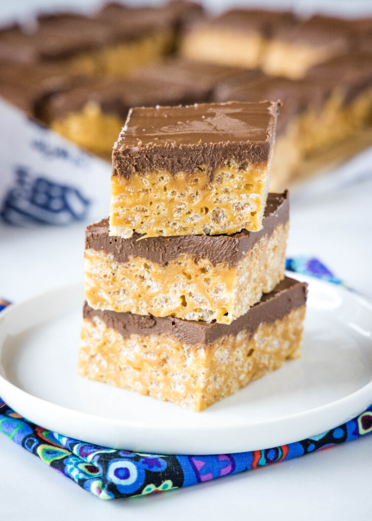 biscoff krispie treats stacked on a white plate