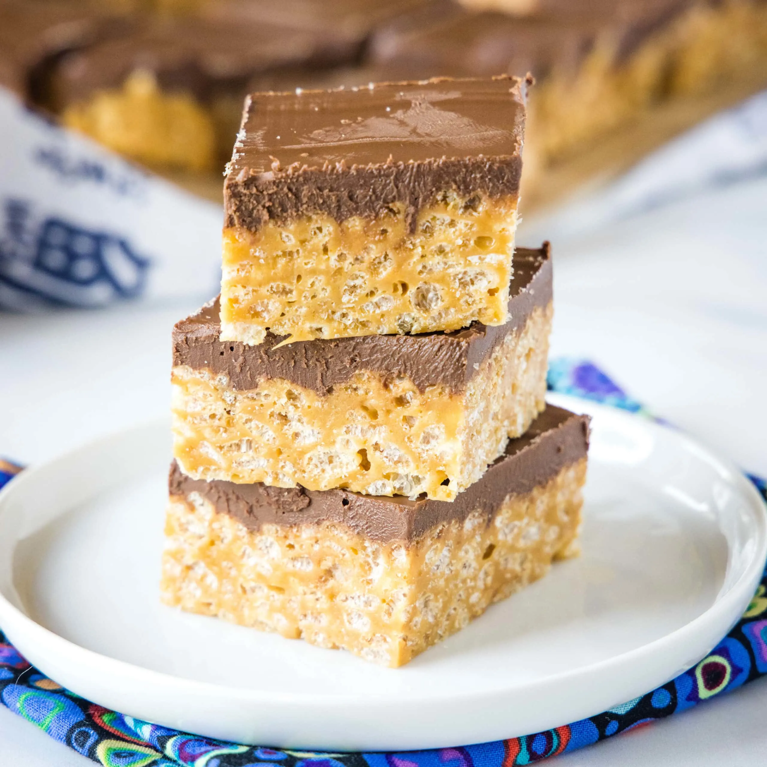 biscoff krispie treats stacked on a white plate