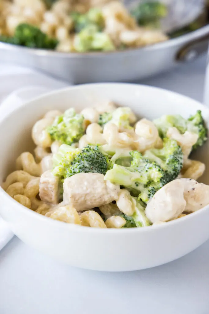 white bowl of chicken broccoli aflredo