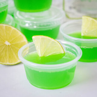 close up margarita jello shots with a slice of lime
