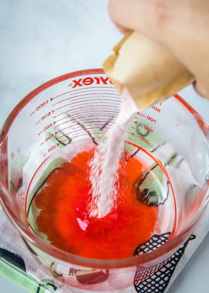 mixing red jello together