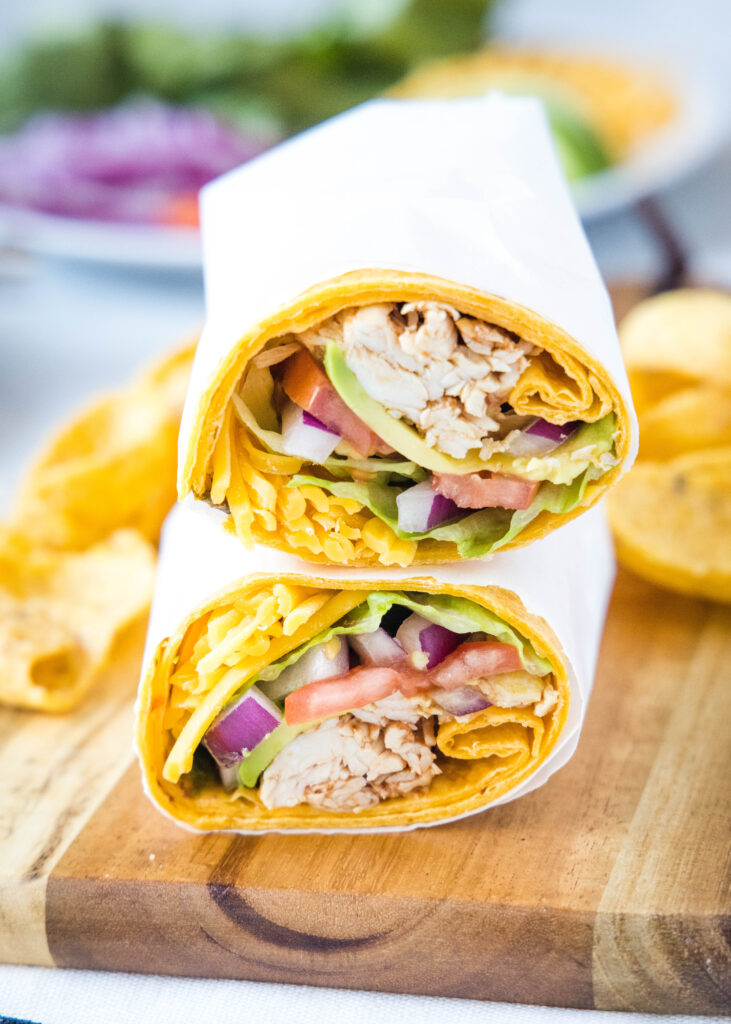 barbecue chicken wrap cut in half stacked ontop of each other on a cutting board