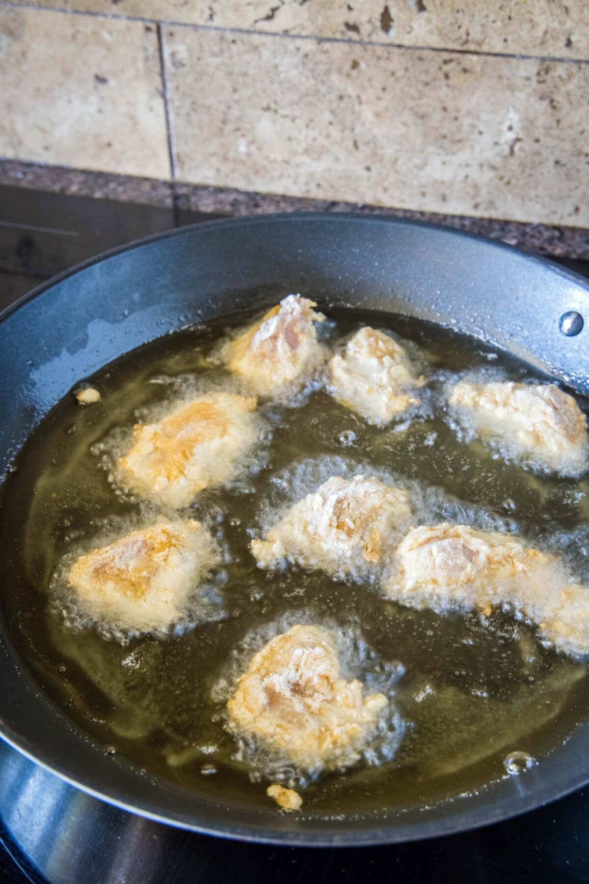chicken frying in oil