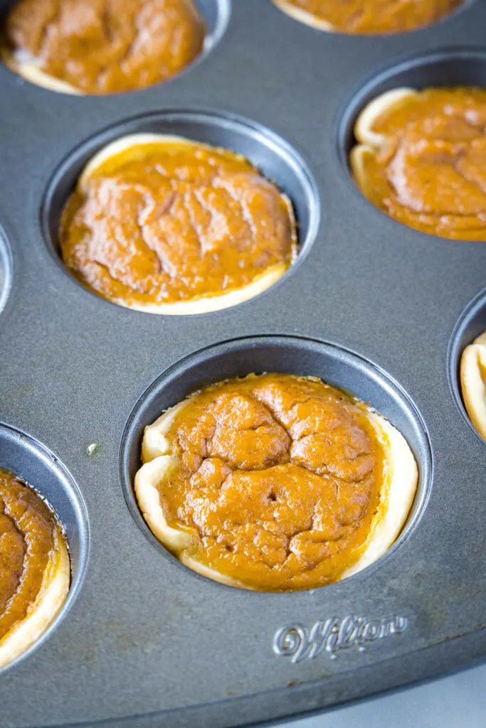 baked mini pumpkin pies in a muffin tin