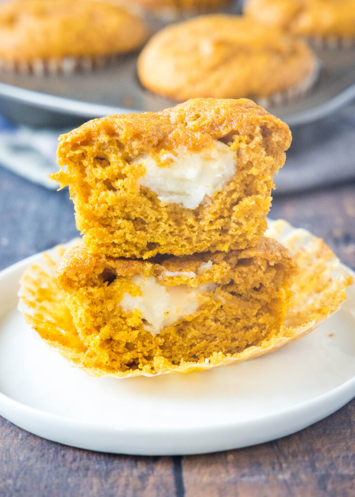 pumpkin cream cheese muffin cut in half and stacked on top of each other