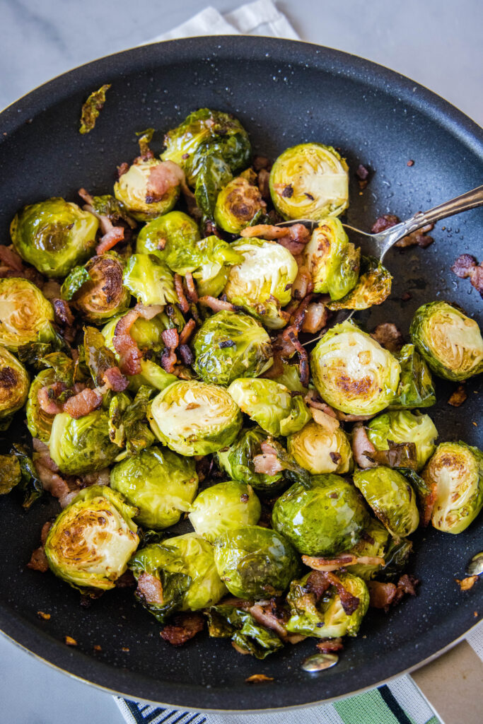 a skillet with brussel sprouts and bacon