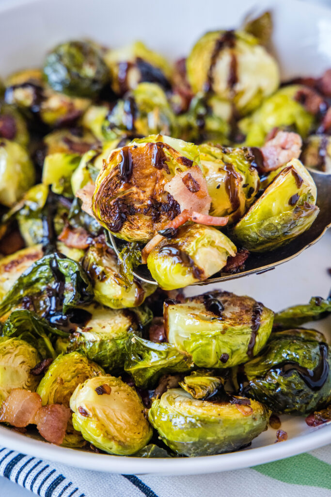 a serving spoon with brussel sprouts and bacon