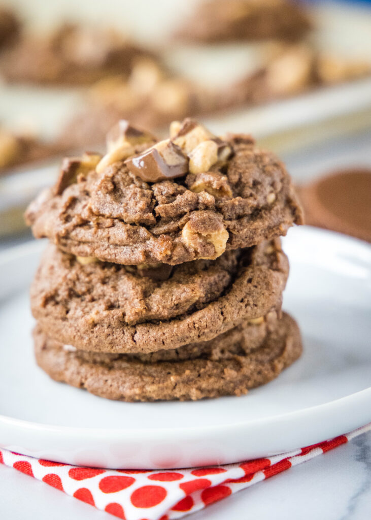 stacked chocolate and peanut butter cookies on a white plate