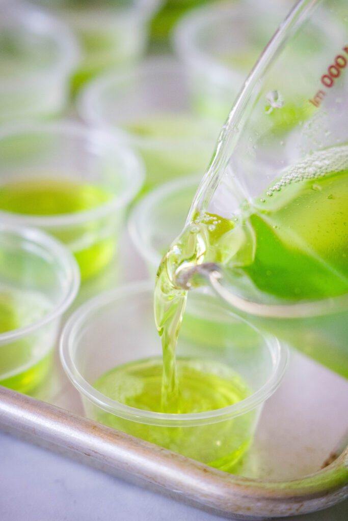 pouring green jello in cups