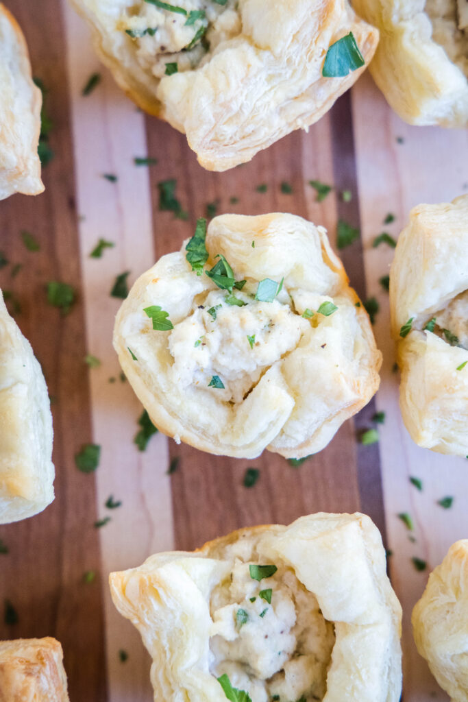 crab puffs sprinkled with parsley on cutting board