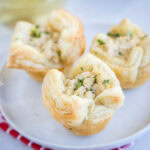 close up 3 crab puffs on a white plate