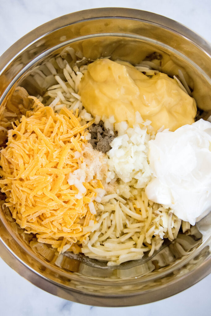 crockpot hashbrown casserole ingredients in a bowl