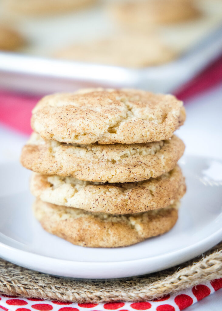 stacked snickerdoodles on a white plate