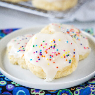 close up sour cream cookies on a white plate