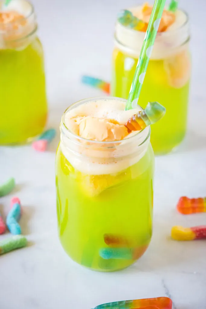 green drink with orange sherbert in a glass