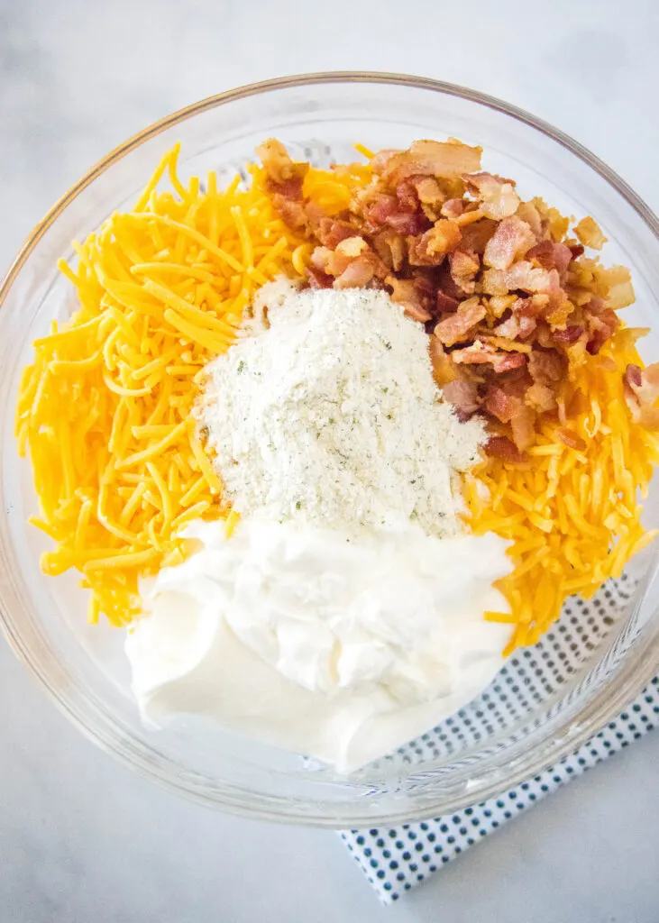 mixing together bacon cheddar ranch dip in mixing bowl