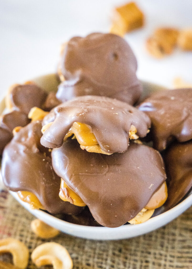 a bowl with chocolate and caramel cashew clusters