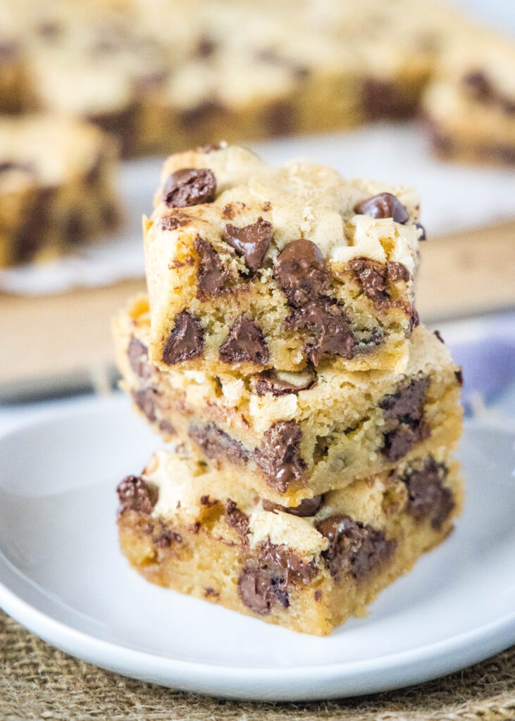 stacked chocolate chip blondies on a white plate