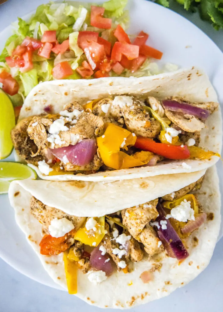 cooked chicken fajitas on a white plate