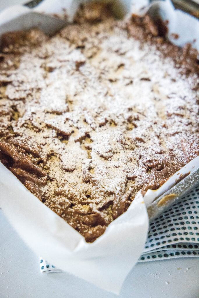 bars in a baking pan with powdered sugar on top