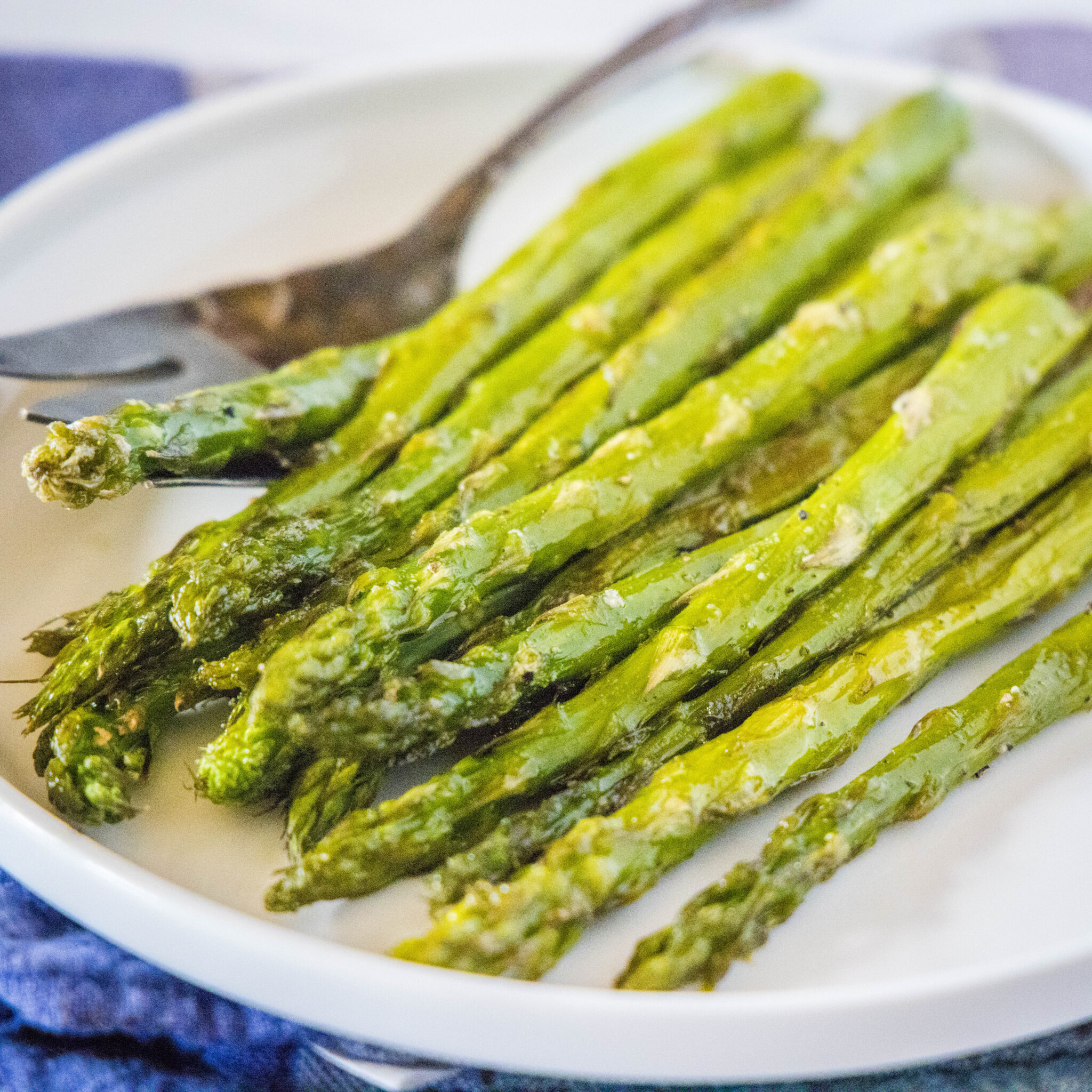 cropped image of asparagus close up on a white plate