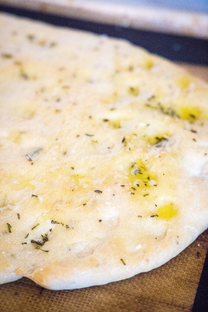 baked focaccia bread on baking sheet