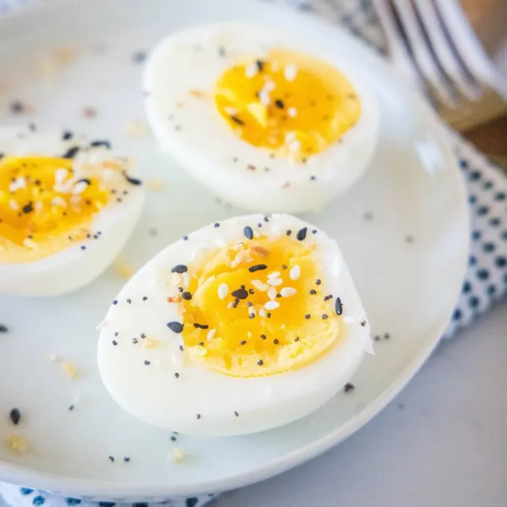 close up hard boiled eggs on a white plate