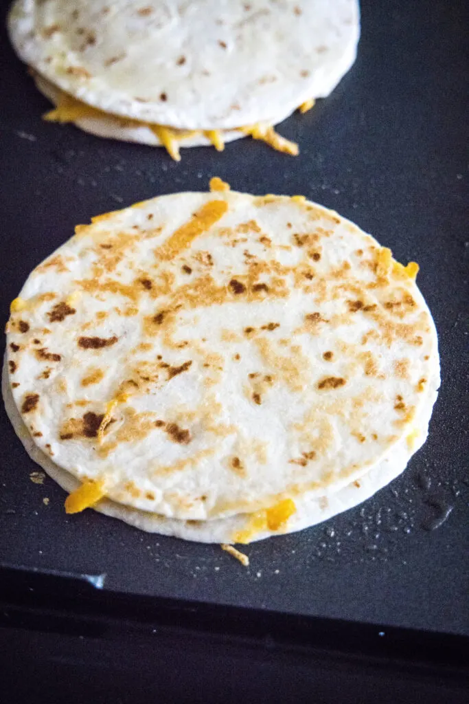 quesadilla cooking on a griddle