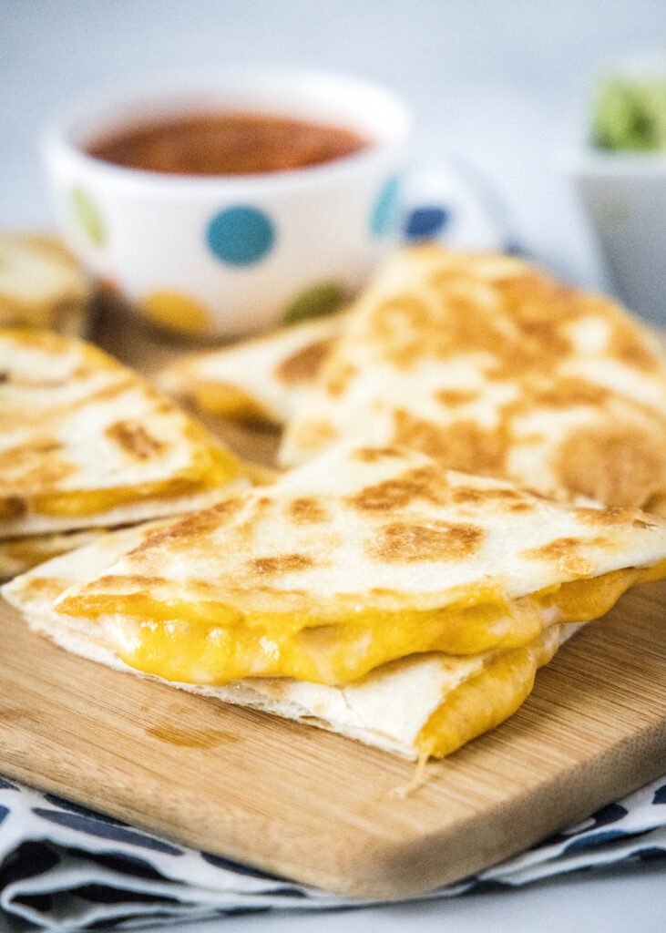 cheese quesadilla on a cutting board
