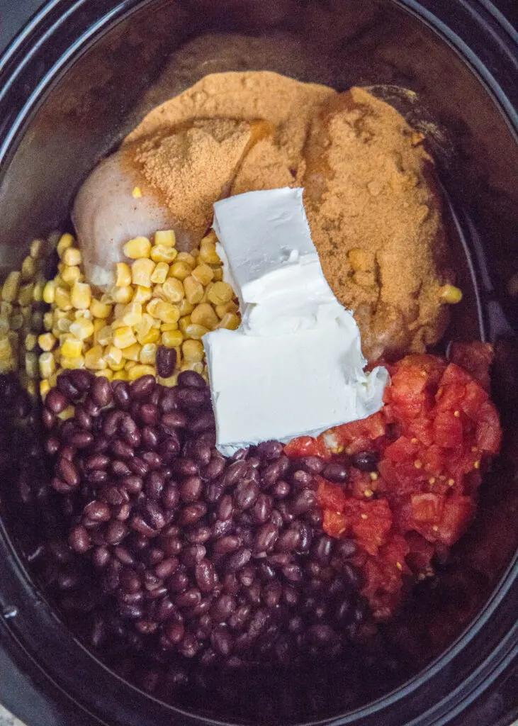 fiesta chicken ingredients in a crock pot ready to cook