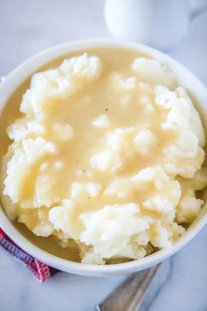a bowl of mashed potatoes topped with gravy
