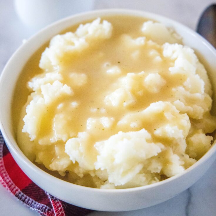 close up mashed potatoes and gravy in a bowl