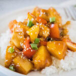close up hawaiian chicken on a plate over rice
