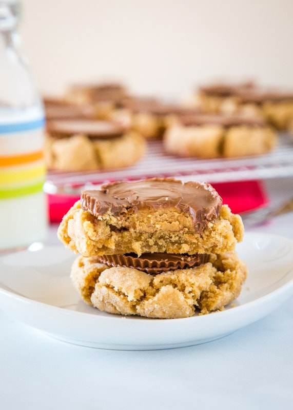 peanut butter blossom cookies stacked on a white plate