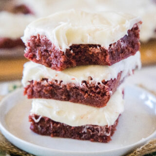 close up stack of red velvet brownies with a bite missing from one