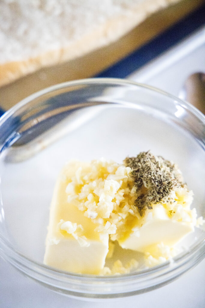 Butter, garlic and Italian seasonings in a bowl