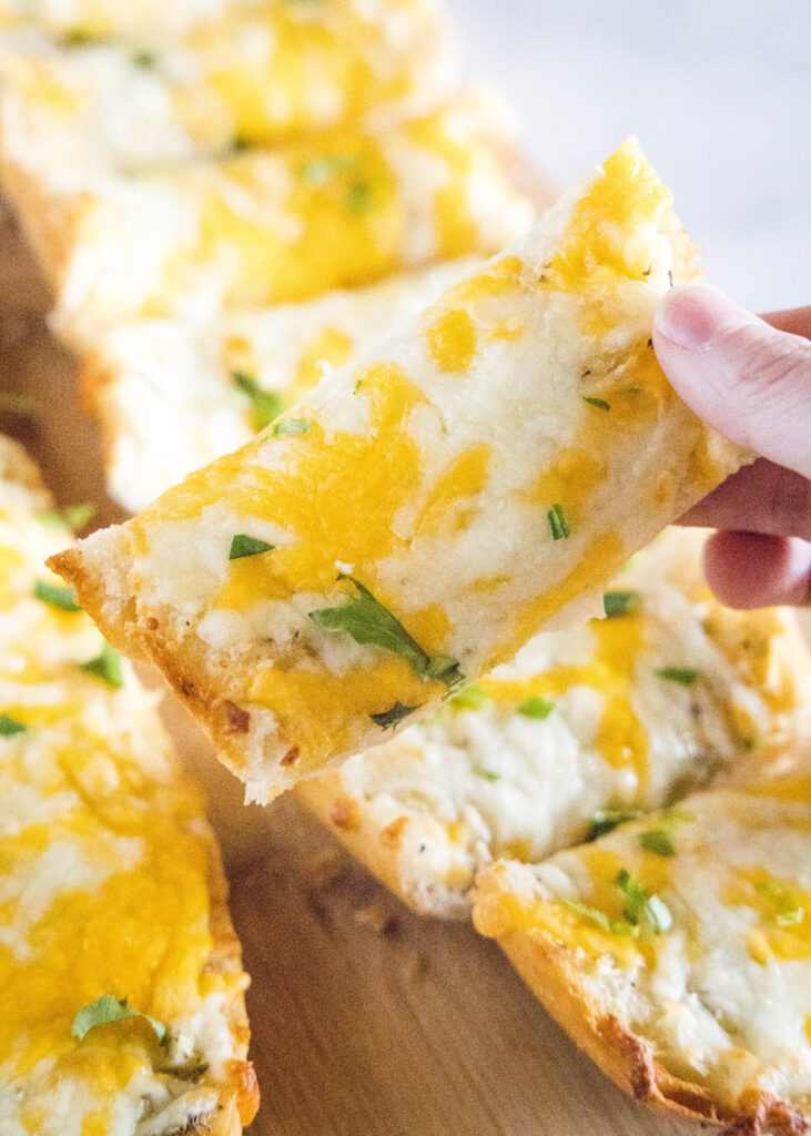 pick up a slice of cheese garlic bread
