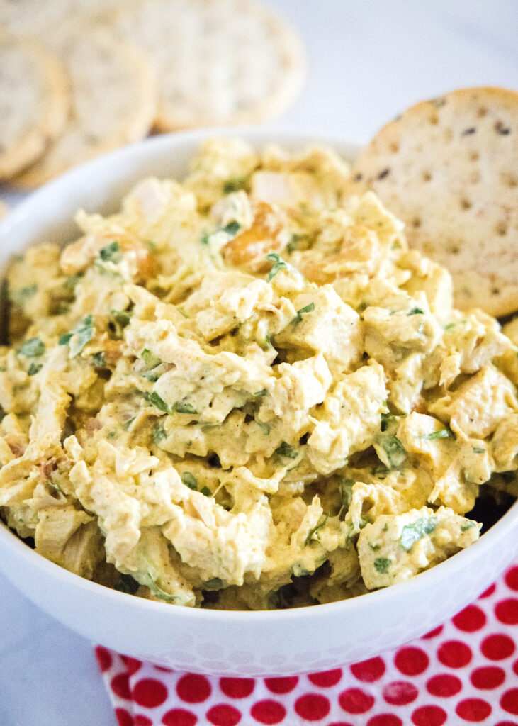 curry chicken salad in a bowl with crackers