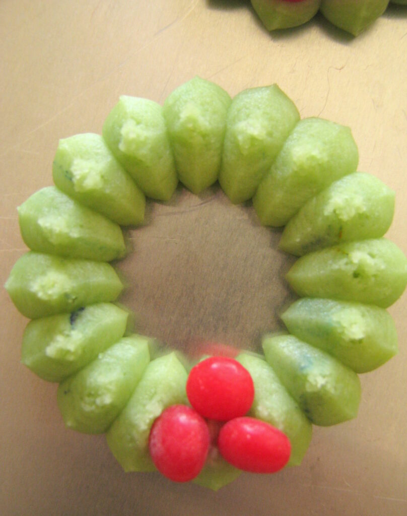 1 holly wreath cookie on baking sheet
